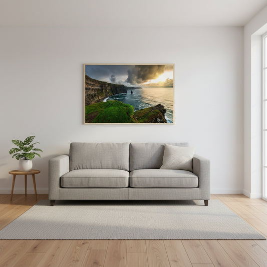 Cliffs of Moher print centred above a grey linen sofa, oak floors, minimal decor, and soft natural light from large windows.
