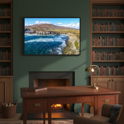 Black-framed Achill Island artwork above a mahogany writing desk, dark green walls, peat fire in the background and shelves filled with leather-bound books.