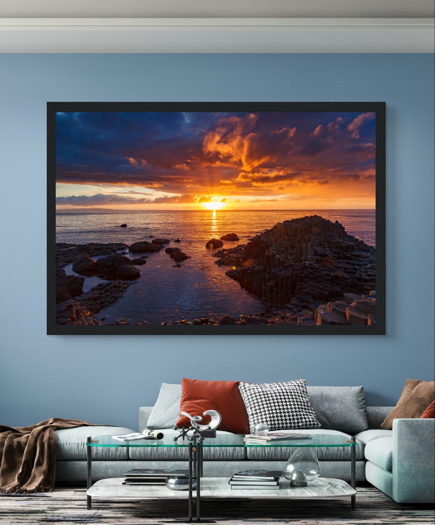 Framed art print of a mesmerizing sunset at Giant's Causeway, showcasing iconic basalt columns against a sky painted with warm hues. The scene captures nature's beauty and tranquility, adding a sophisticated touch to home or office decor. Perfect for any art lover.