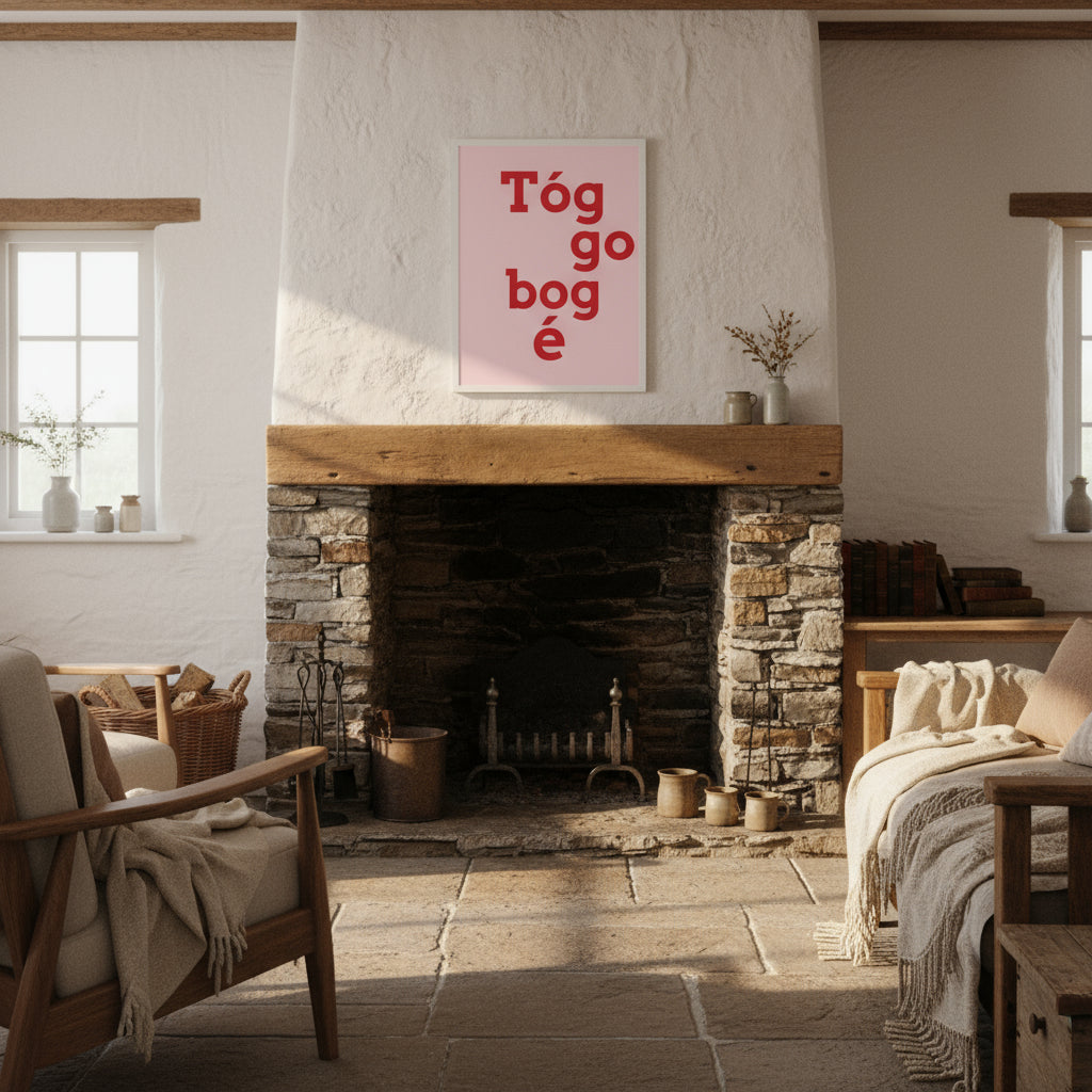 Print in natural wood frame hanging over a stone fireplace in a cosy Irish cottage interior, whitewashed walls, wool throws and soft morning light.